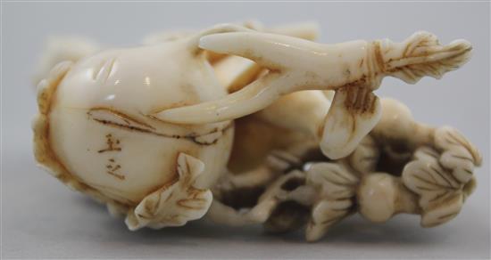 A Japanese ivory okimono of a farmer cutting a large turnip, signed Gyokushi, late 19th / early 20th century, 7cm, slight restorations